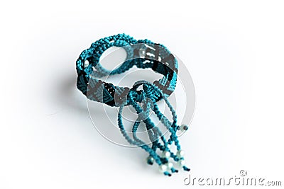 turquoise bracelet for the hand from waxed thread, and dragon eye in the technique of macrame on a white background Stock Photo