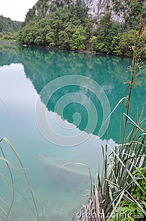 Turquoise clear water with sank Boat at the bottom Stock Photo