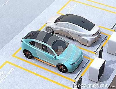 Turquoise green electric SUV and silver self-driving sedan in car share parking lot Stock Photo