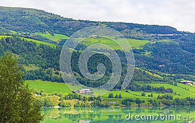 Turquoise green water of fjord river mountains landscape of Norway Stock Photo