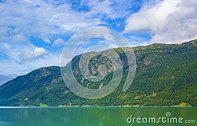 Turquoise green water of fjord river mountains landscape of Norway Stock Photo