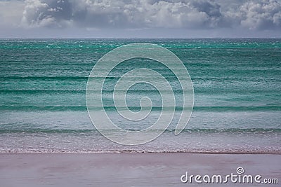 Turquoise ocean waves under stormy clouds - minimalist landscape. Stock Photo