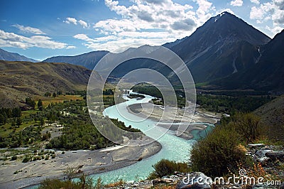 Turquoise river, mountains and skies Stock Photo