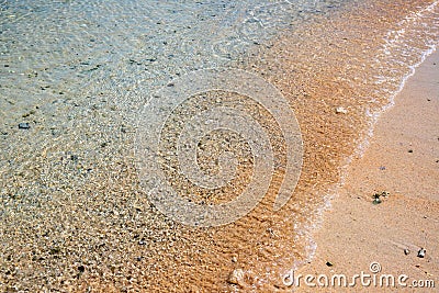 Turquoise sea water on sandy beach. Sea tide on sand. Tropical seaside photo. Marine holiday. Seashore landscape Stock Photo