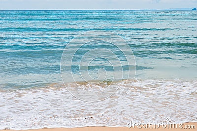 Turquoise sea water and white foam waves on beach Stock Photo