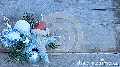 Christmas starfish, pine and bulbs on a rustic wood background Stock Photo