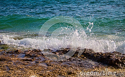 Turquoise water of tropical sea. Waves and stones near coastline. Oceanic landscape. Stock Photo