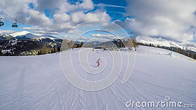 Turrach - A girl going down a snowy slope on a snowboard Stock Photo