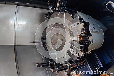 Turret head of CNC lathe tool. Rotating part for working tool change, close up Editorial Stock Photo