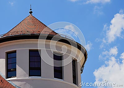 Turret type circular building top with sloped brown clay tile roof Stock Photo