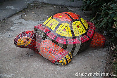Turtle figurine, made of mosaic red yellow. The design of the city Park Stock Photo
