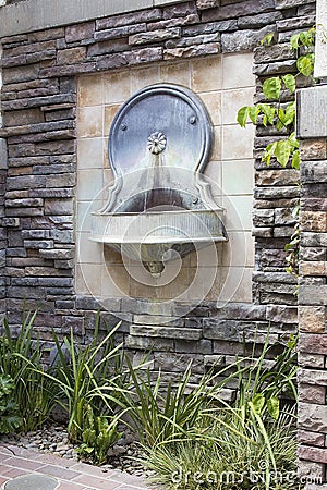 Tuscan Style Wall Water Fountain in Courtyard Stock Photo