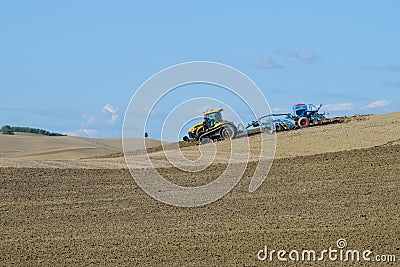 Tracked tractor Challenger MT765D with pneumatic seed drill Lemken Solitair 9 works in the field on a sunny September day Editorial Stock Photo