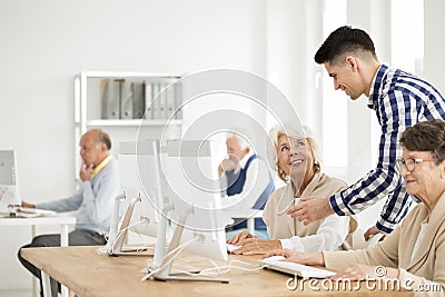 Tutor explaining task to senior Stock Photo