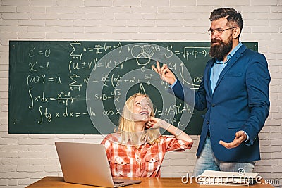Tutor. Student Studying Hard Exam. Teacher couple. Male home tutor helping girl with studies. Teacher collaborates with Stock Photo