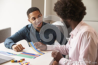 Tutor Using Learning Aids To Help Student With Dyslexia Stock Photo