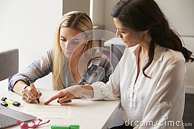 Tutor Using Learning Aids To Help Student With Dyslexia Stock Photo