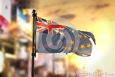 Tuvalu Flag Against City Blurred Background At Sunrise Backlight Stock Photo