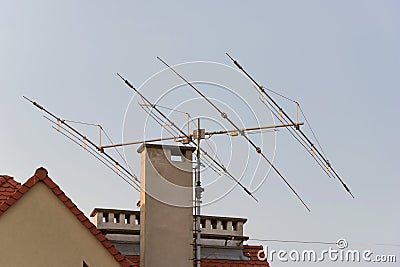 Tv antenna on roof of home. Technology of broadcast television and radio on rooftop. Signal receiver. Tower of transmit media. Stock Photo