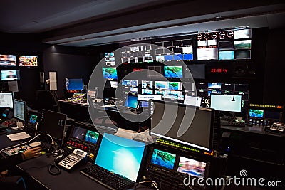 TV Broadcast news studio with many computer screens and control panels for live air broadcast. Stock Photo