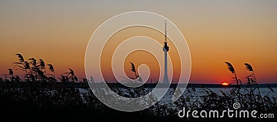 TV broadcast tower silhouette at sunset Techirghiol Eforie Constanta Romania Stock Photo