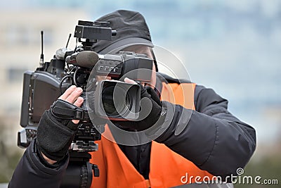 TV camera man filming event Stock Photo