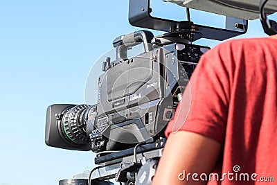 TV camera operator filming event Editorial Stock Photo