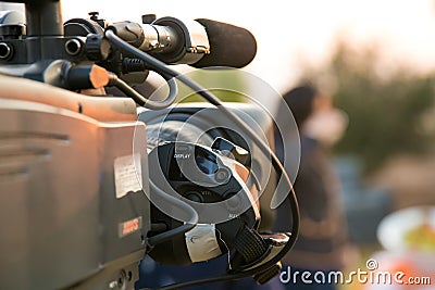 TV Camera and presenter host on a live news broadcast on location Stock Photo