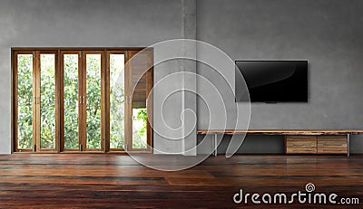 Tv on concrete wall with tall windows in old wooden floors empty room Stock Photo