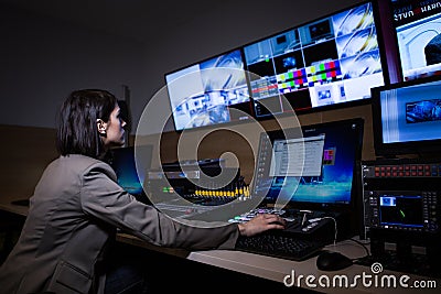 TV director at editor in studio. TV director in a television broadcast gallery.Woman producer sat at a vision mixing panel Editorial Stock Photo