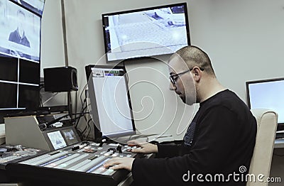 TV editor working with audio video mixer in a television broadcast Stock Photo