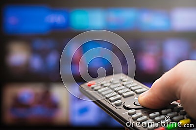 TV remote in hand Stock Photo