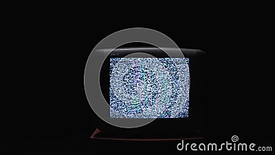 TV screen on at night with a white noise. Stock. Static noise on the old TV screen in the dark Stock Photo