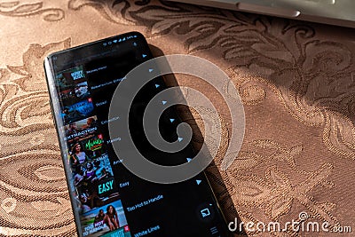 Tv shows and movie displayed on a smartphone screen. Netflix app Editorial Stock Photo