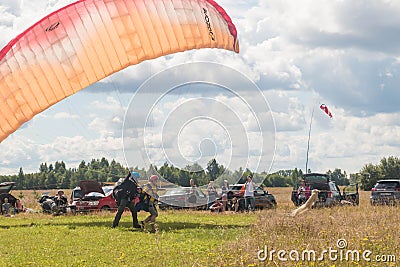 Tandem Paragliding takeoff from the field. Blue sky with clouds Editorial Stock Photo