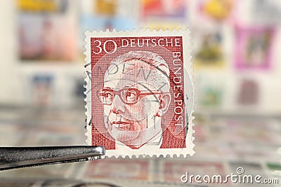 Tweezer holds postage stamp of Germany Federal President Dr. Gustav Heinemann Editorial Stock Photo