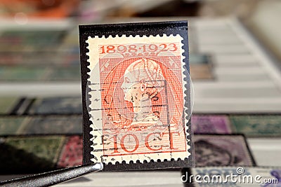 Tweezer holds postage stamp Queen Wilhelmina Reign jubilee Editorial Stock Photo