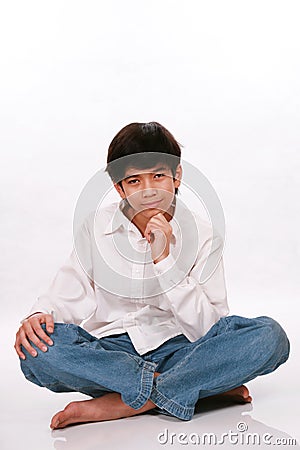 Twelve year old boy sitting, thinking Stock Photo