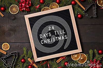 Twenty four Days till Christmas countdown letter board on dark rustic wood Stock Photo