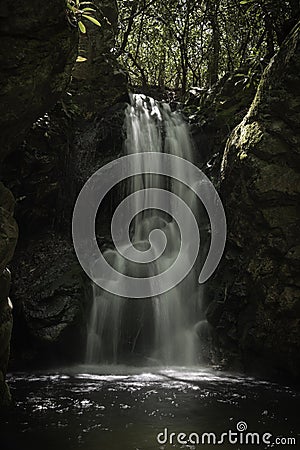 Beautiful waterfall located in a dark, rocky grotto in the Unaka Mountain Wilderness. Stock Photo