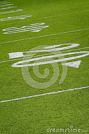 Twenty yard line of football field tilted at an angle Stock Photo