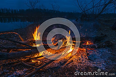Twilight fire bonfire. Inviting campfire at camping in night Stock Photo
