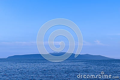 Twilight seascape from Opatija riviera in Croatia. Silhouette of Cres island. Stock Photo