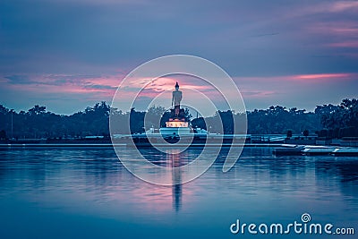 Twilight sky and Buddha statue at PhutthamonthonBuddhist park in Nakhon Pathom Province of Thailand Stock Photo