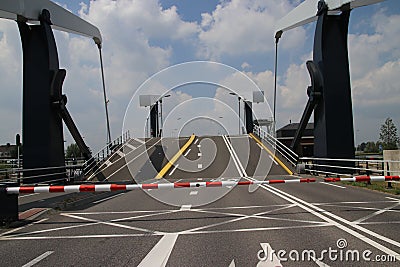 Twin bridge is opening with closed barriers at the sluice named Julianasluis in the Gouwe canal at Gouda, the Netherlands Editorial Stock Photo