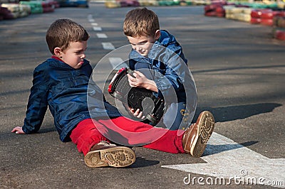 Twin brothers play with a toy car Stock Photo