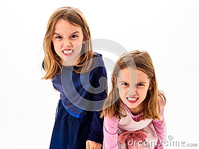 Twin girls are angry, mad and disobedient with bad behavior. Stock Photo