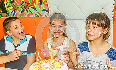 Twin sisters at birthday celebration with cake Stock Photo