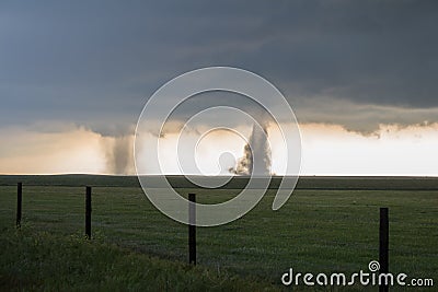 Twin tornadoes churn dirt on the high plains of Colorado. Stock Photo