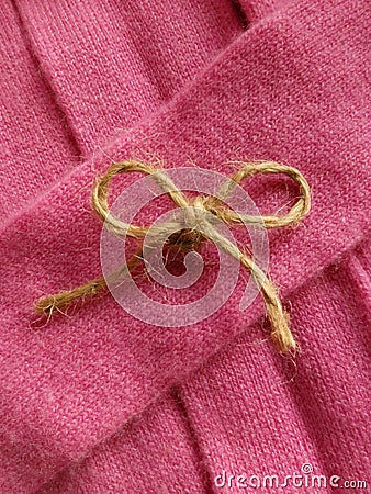 Twine bow on pink cashmere Stock Photo